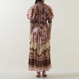 Model wearing Zimmermann dress in Mauve Jacobean, floral print with puff sleeves, smocked cuffs, and tiered maxi skirt, rear view