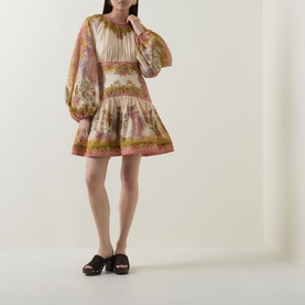 Model wearing Zimmermann dress in Chartreuse Scarf Floral, balloon sleeves, tiered mini skirt, styled with dark brown mule sandals.