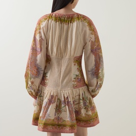 Model wearing Zimmermann dress in Chartreuse Scarf Floral, shown from behind, featuring billowy long sleeves and tiered skirt hem.