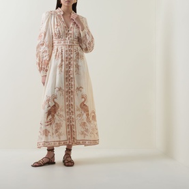 Model wearing Zimmermann Indra Linen Plunge Dress in Cream Tan Floral, midi length with billowed sleeves and peacock print, styled with brown sandals.