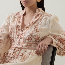 Model wearing Zimmermann Indra Linen Plunge Dress in Cream Tan Floral, featuring billowed sleeves, crochet button-front and fitted waist