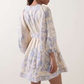 Model wearing Zimmermann dress in Cream Lilac Floral, featuring long balloon sleeves, cinched waist, and flared mini skirt, shown from behind.