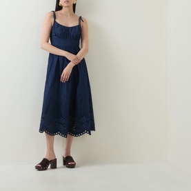 Model wearing Zimmermann ink midi dress with tie shoulder straps, broderie anglaise hem detail, styled with brown block-heel mules.