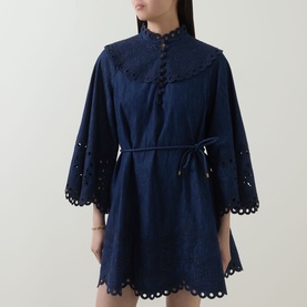 Model wearing Zimmermann ink dress with broderie anglaise detail, scalloped hem, flared sleeves and tie waist