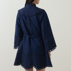 Model wearing Zimmermann Ink dress, rear view, broderie anglaise detailing on yoke, cuffs and hem, with self-tie waist belt