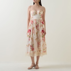 Model wearing cream floral midi dress with sweetheart neckline, thin straps, and lace hem, styled with gold jewellery and strappy heels
