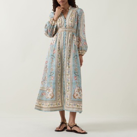 Model wearing Zimmermann Roselight Tapestry Floral Dress in Blue Tapestry Floral, midi length, V-neckline, billowing sleeves, styled with black