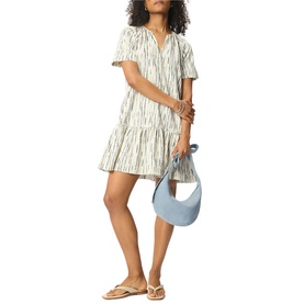 Model wearing Whistles cream abstract-print tiered mini dress with short sleeves, styled with tan sandals and a light blue shoulder bag.