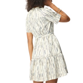 Model wearing Whistles cream tiered mini dress with abstract stripe print, short sleeves, and belted waist, seen from behind.