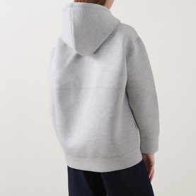 Model wearing InWear Asvin Zip Hoodie in New Light Grey M, showing back view with dropped shoulders and drawstring hood, styled with navy trousers.