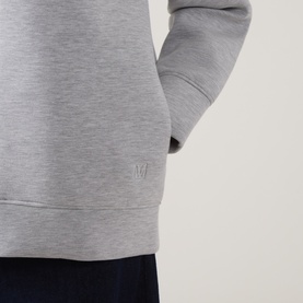 InWear Asvin Zip Hoodie in New Light Grey M, close-up of tonal logo detail on melange fabric with ribbed hem, styled with navy trousers.