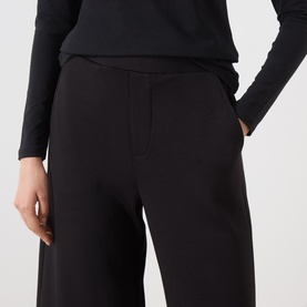 Model wearing InWear black wide-leg trousers with side pockets, styled with a black long-sleeve top.