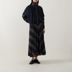 Model wearing Luisa Cerano anthracite knitwear zip-up top, styled with dark plaid midi skirt and black loafers.