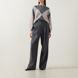 Model wearing Luisa Cerano multi argyle knit sweater with grey wide-leg tailored trousers and black pointed-toe heels.