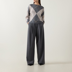 Model wearing Luisa Cerano multi argyle knit sweater with grey wide-leg tailored trousers and black flat shoes.