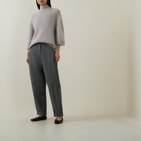 Model wearing Luisa Cerano pearl alpaca-blend knitwear with mock neck and wide sleeves, styled with grey tapered trousers and black ballet flats.