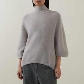Model wearing Luisa Cerano pearl alpaca-blend knit jumper with mock neck and cropped sleeves, styled with grey wide-leg trousers.