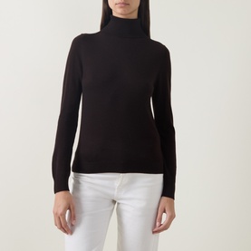 Model wearing Luisa Cerano Solid Turtleneck Sweater in Truffle, fine knit wool-silk-cashmere blend, styled with white jeans.