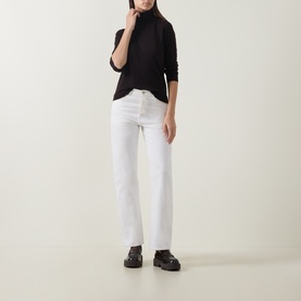 Model wearing Luisa Cerano Solid Turtleneck Sweater in Truffle, fine knit, long sleeves, styled with white straight-leg jeans and black chunky