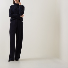 Model wearing Luisa Cerano Winter Navy knit turtleneck jumper, styled with wide-leg trousers and black shoes.