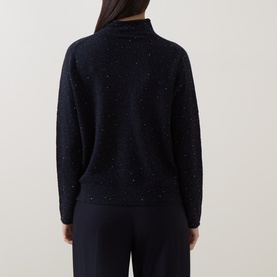 Model wearing Luisa Cerano Winter Navy flecked knit jumper with mock neck, shown from behind, styled with navy wide-leg trousers.