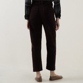 Model wearing Luisa Cerano Velvet Barrel Leg Cropped Trousers in Truffle, back view, styled with a plaid shirt and loafers