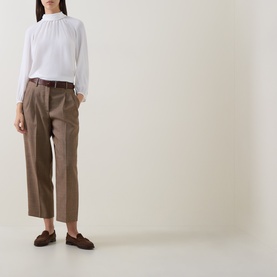 Model wearing Luisa Cerano multi-coloured tailored trousers with white gathered-neck blouse, brown belt and loafers