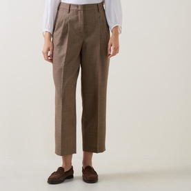 Model wearing Luisa Cerano multi-tone tailored trousers with front pleats and cropped wide-leg silhouette, styled with brown loafers