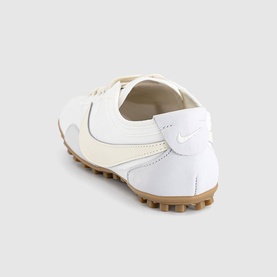 Nike Moon Shoe Trainers in Summit White and Soft Pearl, rear three-quarter view showing leather accents, Swoosh branding and gum Waffle outsole.
