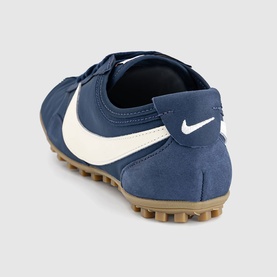 Nike trainer in Midnight Navy and Soft Pearl, suede upper with white swoosh, gum rubber sole, rear three-quarter view
