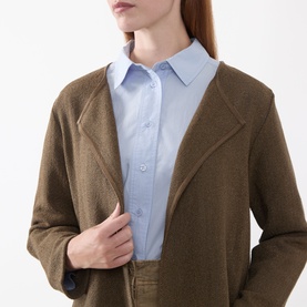 Model wearing Masai Slate Black cardigan with notch lapels, styled with a light blue collared shirt.