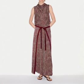 Model wearing Jigsaw red paisley sleeveless maxi dress with high neck and burgundy velvet tie belt, styled with black sandals.