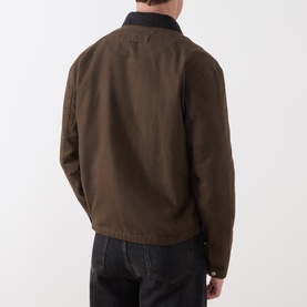 Model wearing Paige Casual Jacket in Pinecone brown, rear view, with black contrast collar and dark jeans.