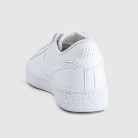 Nike Court Vintage trainers in white, smooth leather upper, white swoosh logo, white midsole and outsole, heel and side angle view