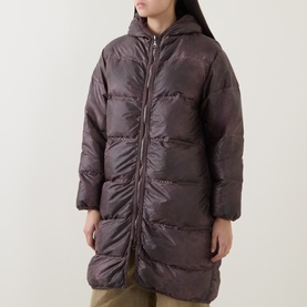 Model wearing Transit rust hooded puffer coat, mid-length with quilted panels and zip fastening, in shiny polyester fabric