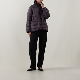 Model wearing Transit choco quilted silk padded jacket with black tapered trousers and black ballet flats.