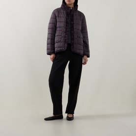 Model wearing Transit choco quilted silk jacket with stand collar, styled with black trousers and flat shoes.
