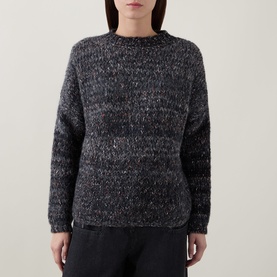 Model wearing dark grey marl chunky knit crew neck sweater with multicolour fleck detail, styled with black trousers