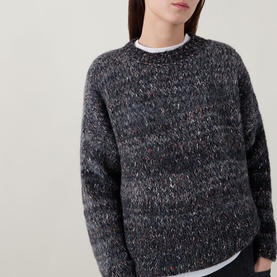 Model wearing dark marled knit crew neck jumper with speckled detail, styled with white T-shirt underneath