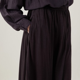 Model wearing Transit skirt in Choco, elasticated waist, relaxed wide-leg silhouette in 100% virgin wool, styled with matching top