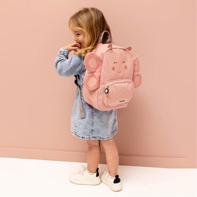 Child wearing Trixie pink fluffy animal character backpack with ear details, styled with denim jacket and white trainers