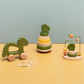 Trixie wooden dinosaur toy set in green and yellow, including pull-along rocker, stacking rings, and bead maze