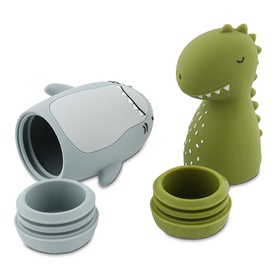 Trixie silicone dinosaur and shark bath toys in olive green and grey, shown separated to reveal hollow interiors