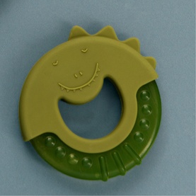 Trixie green dinosaur silicone baby teething ring with textured bite section and embossed face detail