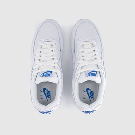 Nike Air Max 90 trainers in white with blue crystal detail, white laces and white sole, overhead flat lay view showing both shoes
