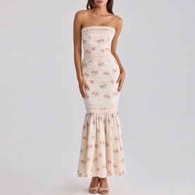 Model wearing House of CB strapless maxi dress in Ivory Vintage Rose with floral print and tiered ruffle hem