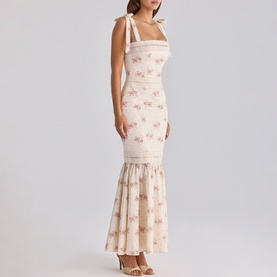 Model wearing House of CB Ivory Vintage Rose floral maxi dress with tie shoulders and ruched mermaid hem