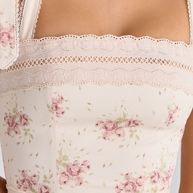 Model wearing House of CB Ivory Vintage Rose floral corset top with lace trim detailing at bust.