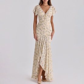 Model wearing House of CB Ivory Vintage Rose floral maxi dress with flutter sleeves, deep V-neck, and asymmetric hem.