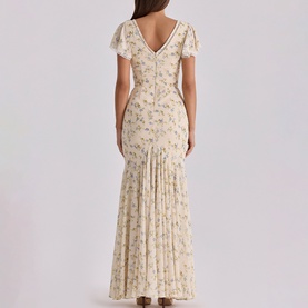 Model wearing House of CB Ivory Vintage Rose floral maxi dress with flutter sleeves, V-back neckline and pleated mermaid hem.